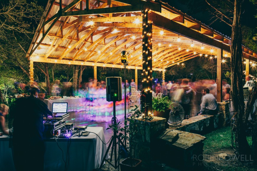 The DJ plays for the wedding guests during the reception at an outdoor veranda