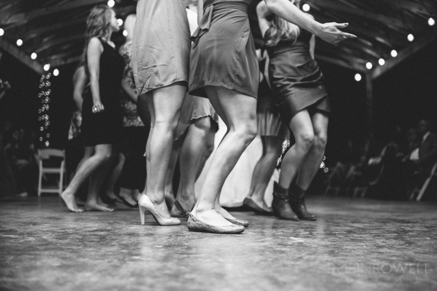 Detail photo of ladies legs line dancing during a wedding reception