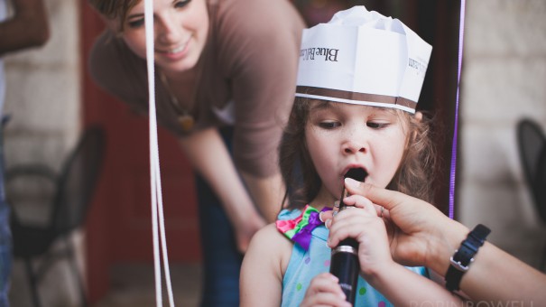 A young girl tries a clarinet for the first time at the Austin Symphony Orchestra "Children's Art Park"
