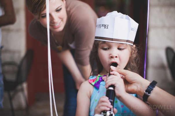 A young girl tries a clarinet for the first time at the Austin Symphony Orchestra "Children's Art Park"