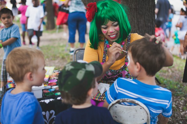 Young boys look on in awe as their friend gets a skull facepainting at the Austin Symphony Orchestra "Children's Art Park"