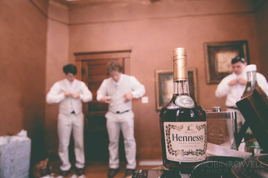 A bottle of Hennessy Cognac foreshadows what is to come - ranch style wedding in Leander, TX