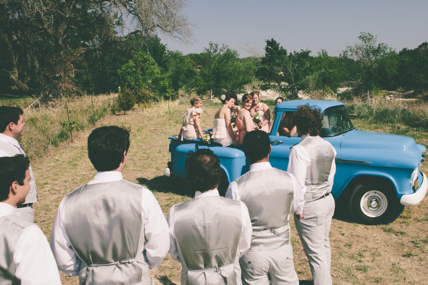The bridal party arrives at the wedding ceremony in a classic pickup truck - ranch style wedding in Leander, TX