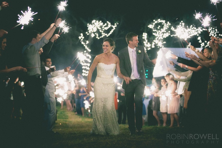The guests light up sparklers for the newlyweds grand exit - ranch style wedding in Leander, TX