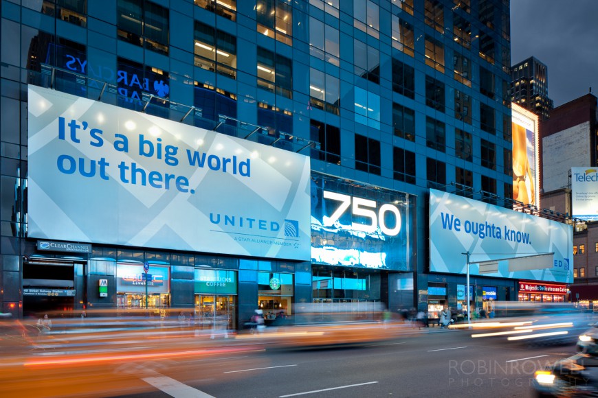 A "United Airlines - It's a big world out there." two panel billboard on 7th Ave in NYC