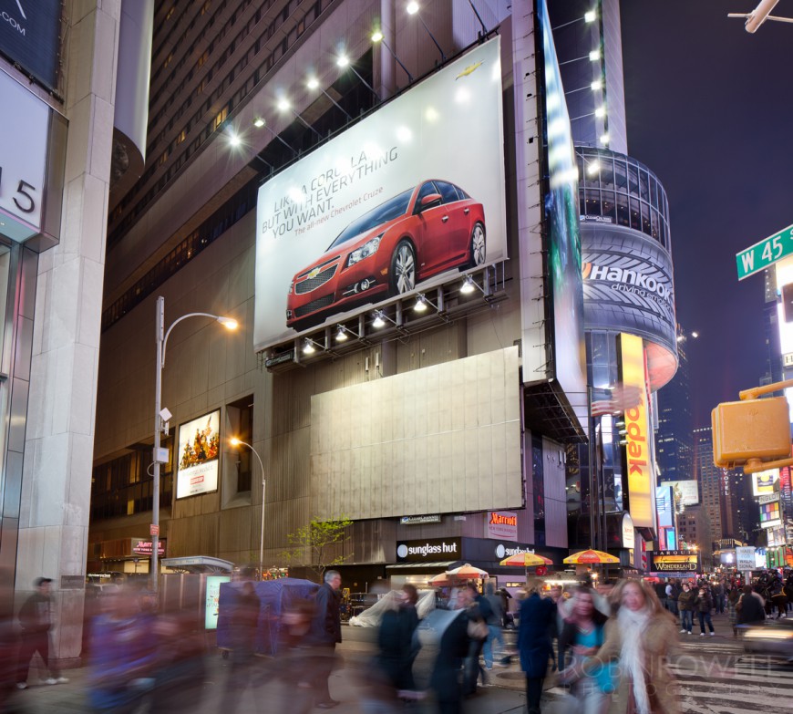 A "Chevy Cruze" ad looms above pedestrians in Times Square, NYC