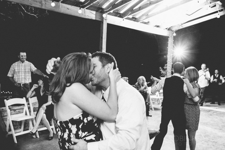 A passionate kiss by guests during the wedding reception