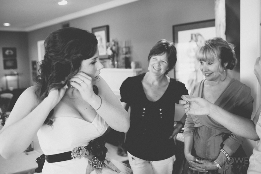 The moms look on with pride at the bride as she gets ready