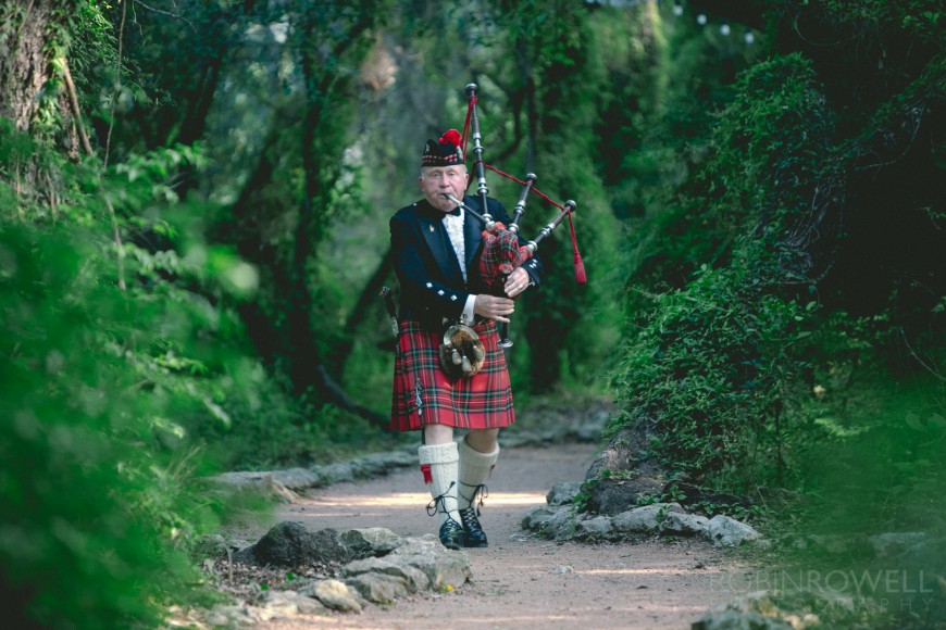 The wedding begins as a bagpiper plays his pipes while walking down the ivy-laden paths of Laguna Gloria - Austin, TX