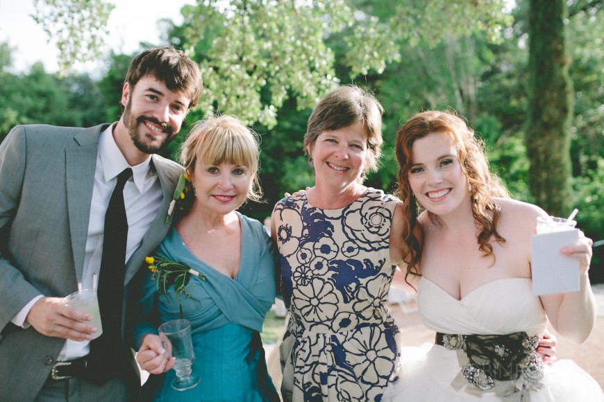 A happy bride and groom with their mothers