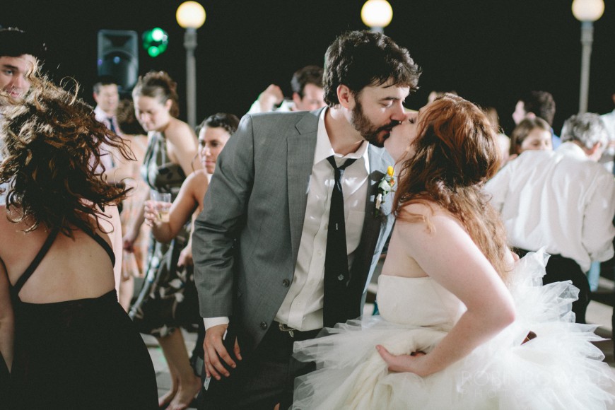 Everyone dances while the bride and groom exchange a kiss at Laguna Gloria - Austin, TX