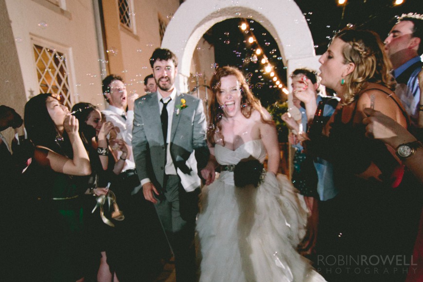Bubbles fly by at the grand exit of the bride and groom at Laguna Gloria - Austin, TX