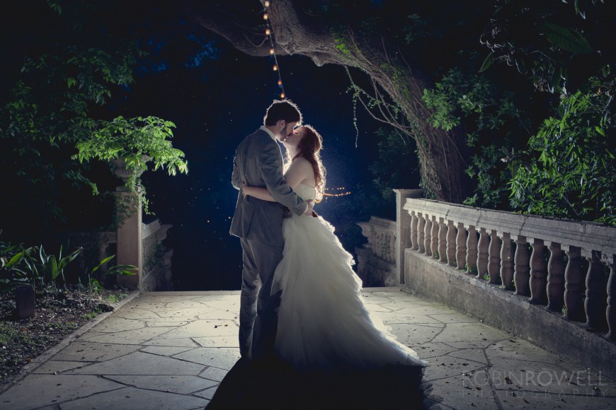 A southern country style classy moonlight kiss between newlyweds at Laguna Gloria in Austin TX