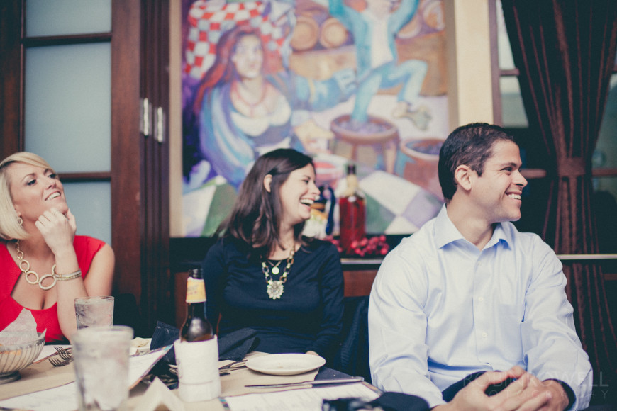 Guests laugh during the rehearsal dinner at Grotto Ristorante - Woodlands, TX