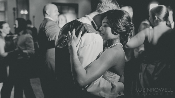 A cinematic balck and white photos of the newlyweds dancing during the reception The Woodlands Country Club - Palmer Course