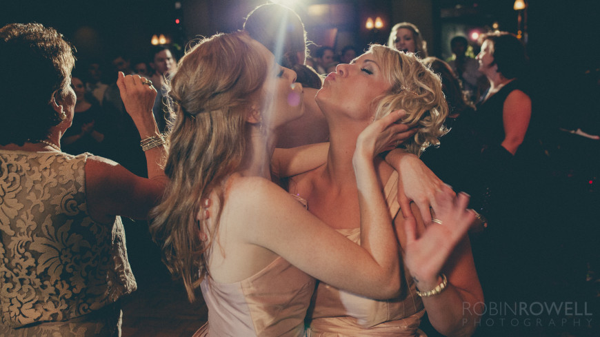 Bridesmaids share a mock kiss during the daning The Woodlands Country Club - Palmer Course