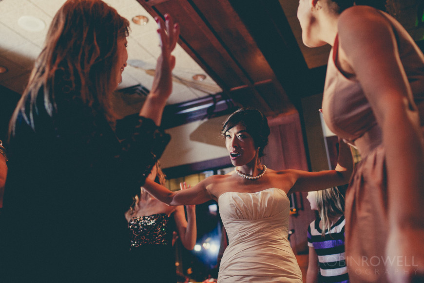 An up angle view of the bride dancing with friends at The Woodlands Country Club