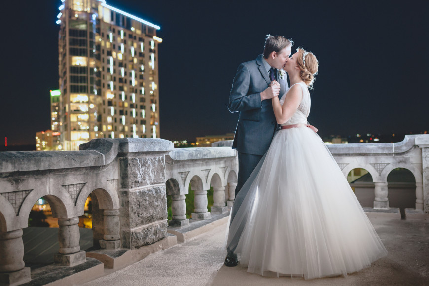 A romantic wedding kiss on the top floor of the Chateau Bellevue in Austin, Texas